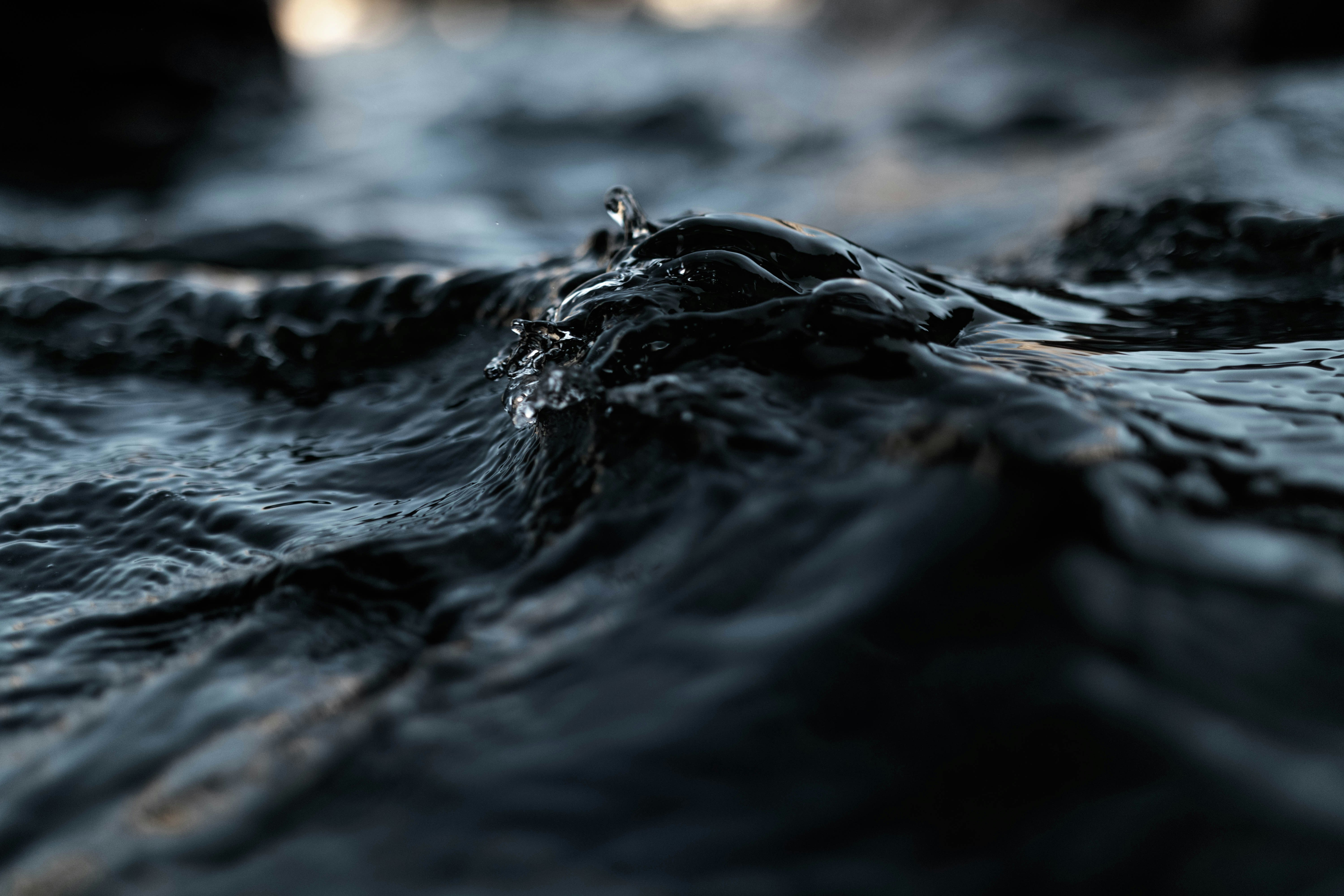 close up photo of black water at daytime